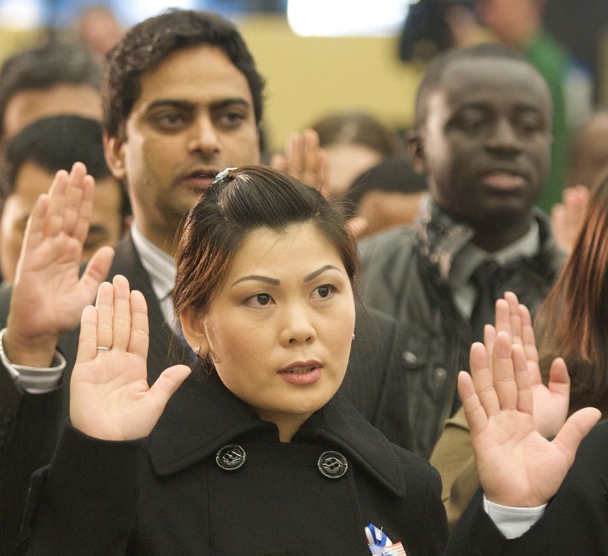 A woman holding up her hand in front of a crowd