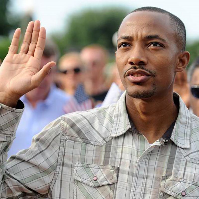 A man waving his hand in front of a crowd.